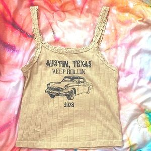 Tan tank top with design on it.